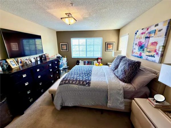 a bedroom with a bed and dresser with mirror