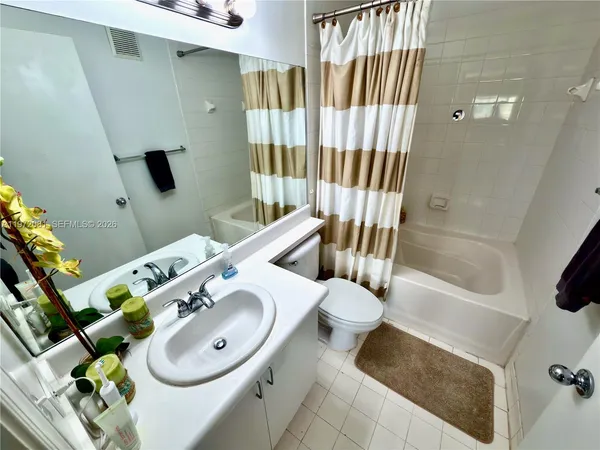 a bathroom with a sink mirror and toilet