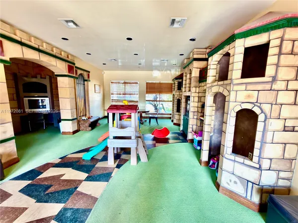 a play room with furniture and a flat screen tv