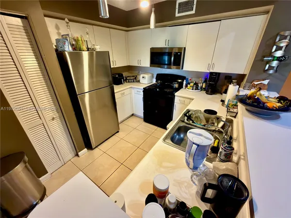 a kitchen with a sink appliances and cabinets