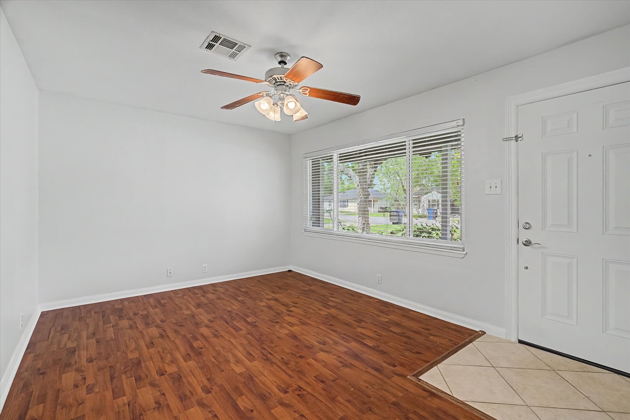 413 Farrer Street Angleton, TX 77515 - Photo 6 of 43 wooden floor in an empty room with a window
