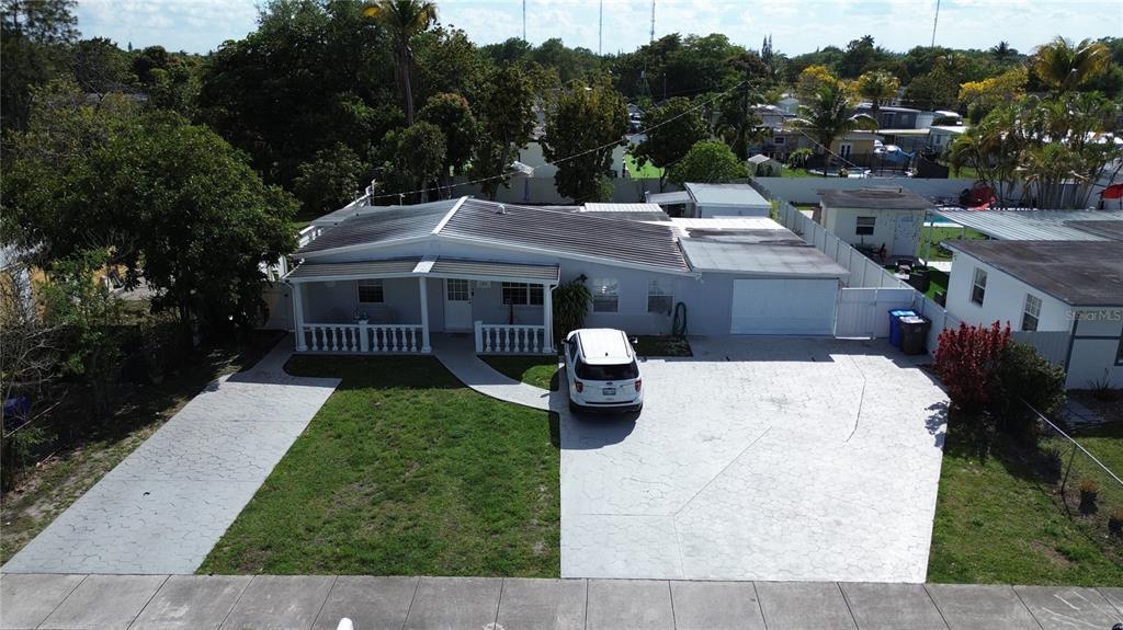 126 Miami Gardens Road West Park, FL 33023 - Photo 1 of 55 a view of a house with a garden