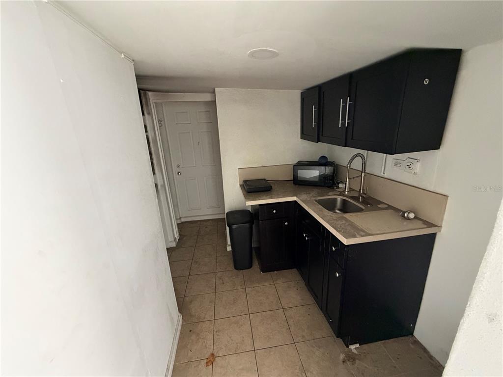 126 Miami Gardens Road West Park, FL 33023 - Photo 22 of 55 a kitchen with a sink and a stove