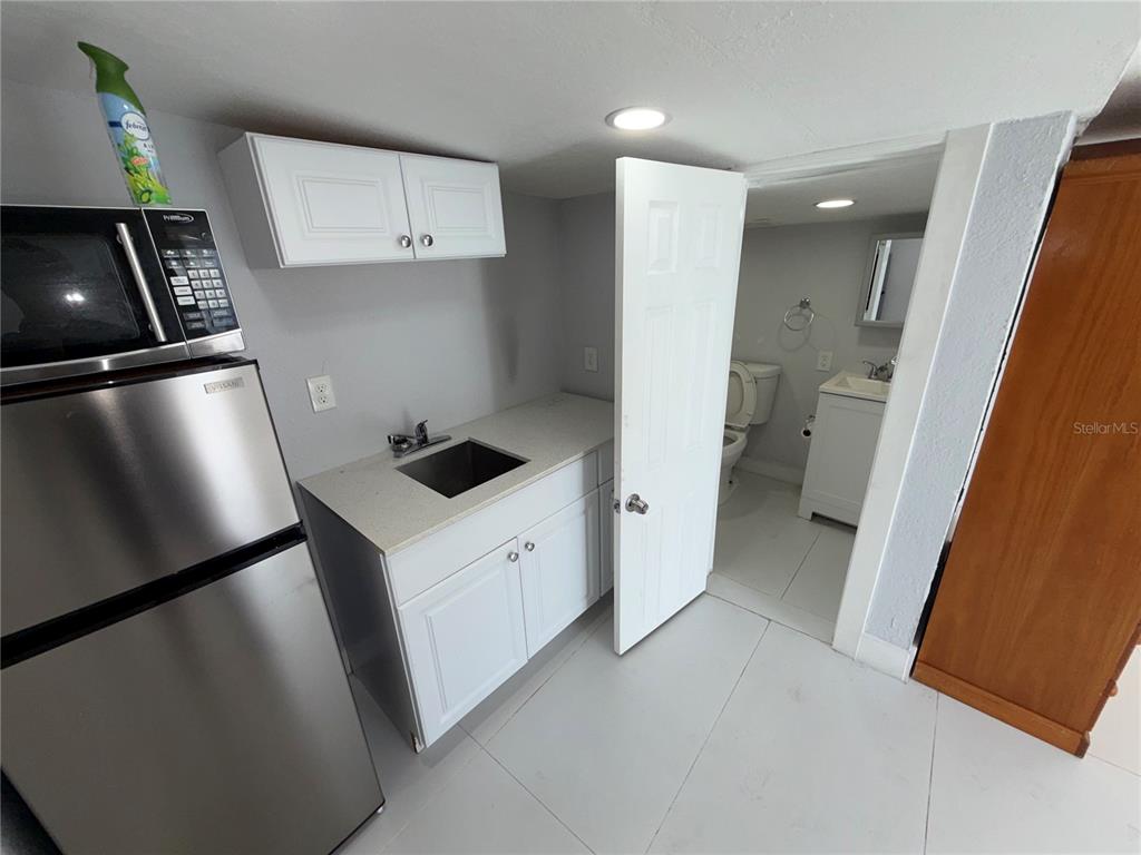 126 Miami Gardens Road West Park, FL 33023 - Photo 33 of 55 a kitchen with a refrigerator and a stove