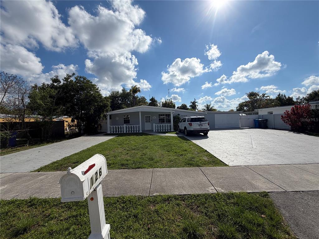 126 Miami Gardens Road West Park, FL 33023 - Photo 4 of 55 a front view of a house with garden