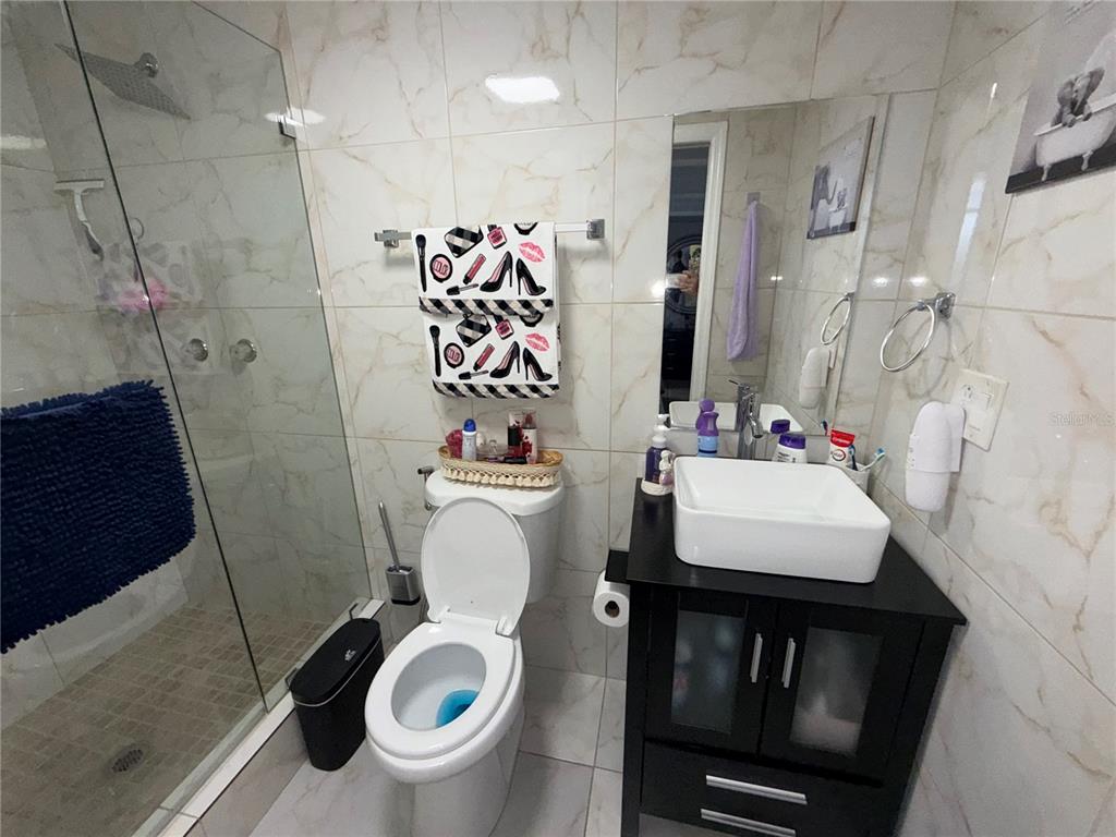 126 Miami Gardens Road West Park, FL 33023 - Photo 45 of 55 a bathroom with a toilet sink and mirror