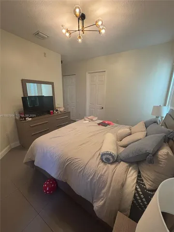 a bedroom with a bed and dresser