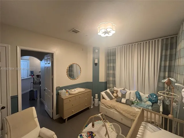 a living room with furniture and a mirror