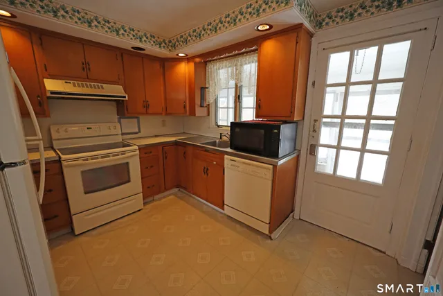 a kitchen with a stove a sink and a microwave