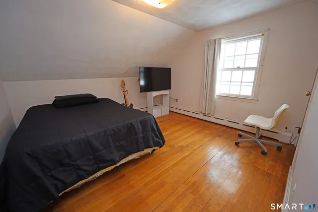 a bedroom with a bed and a desk