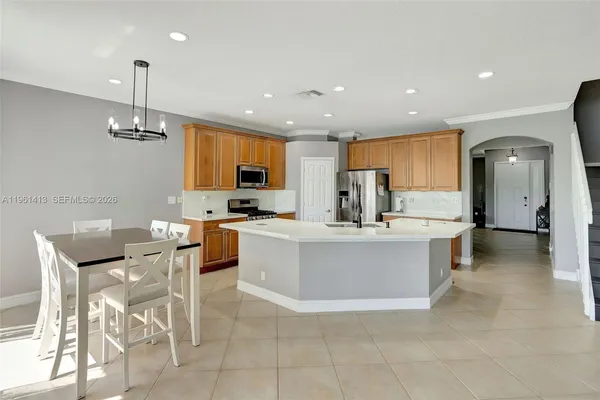 a kitchen with stainless steel appliances kitchen island granite countertop a sink and cabinets