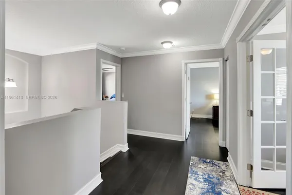 a view of a room with wooden floor and a bathroom