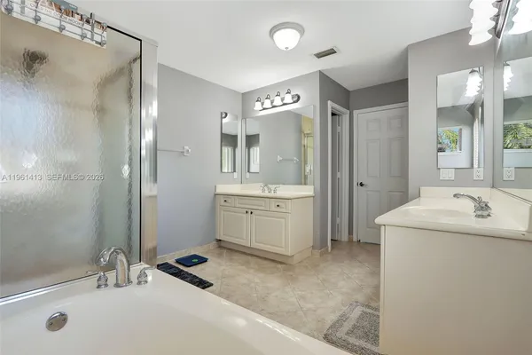 a bathroom with a sink double vanity and a shower