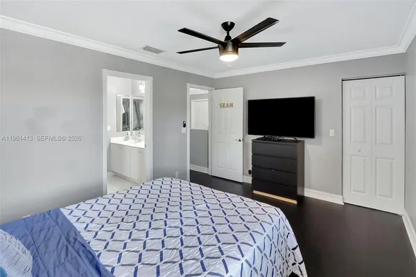 a bedroom with a bed and a flat screen tv