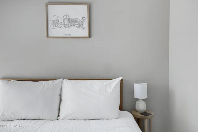 a white bed sitting in a bathroom next to a white wall