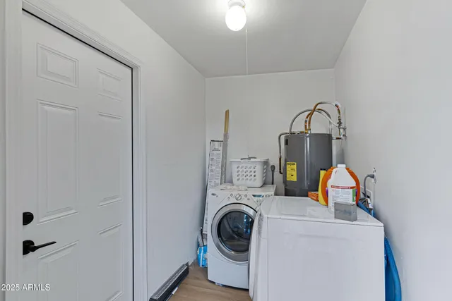 a view of storage and utility room with washer and dryer