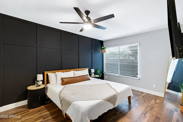 a bedroom with a bed and wooden floor