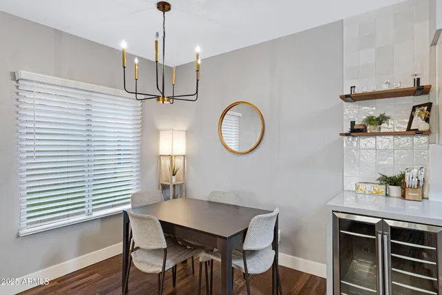 a dining room with wooden floor a sink and a window