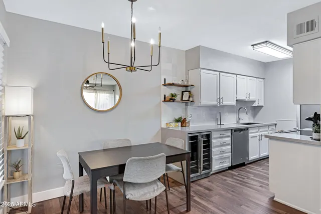 a kitchen with a table chairs sink and cabinets