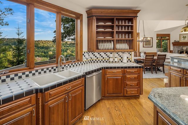 a kitchen with stainless steel appliances granite countertop a sink and a stove