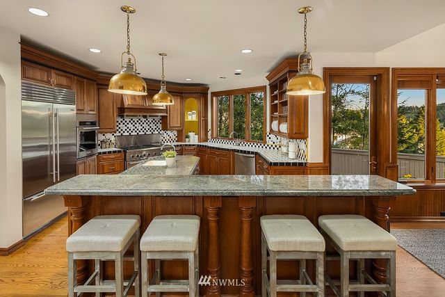 a kitchen with a kitchen island a stove and a chandelier