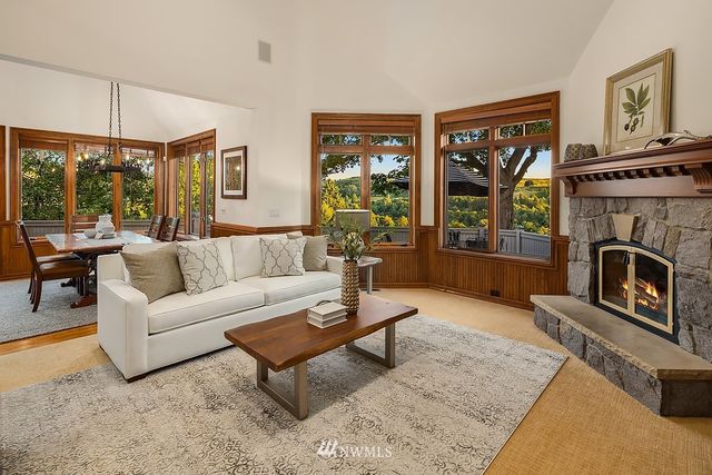 a living room with furniture a large window and a fireplace