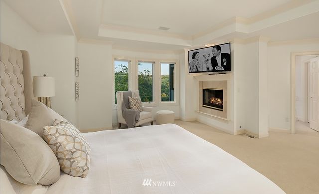 a bedroom with a bed and a fireplace
