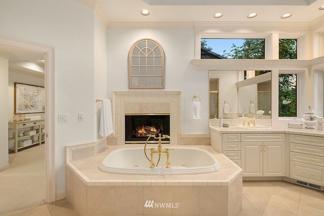 a large white kitchen with a fireplace