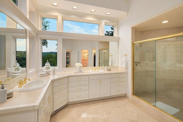a spacious bathroom with a shower sink and mirror