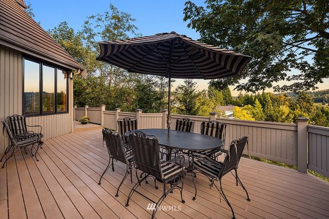 a view of balcony with table and chairs