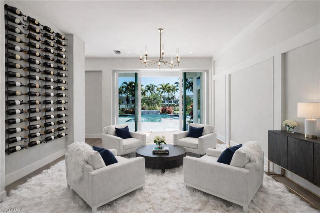 16716 Enclave Circle Naples, FL 34110 - Photo 16 of 50 Living area with suspended lighting and wood finished floors