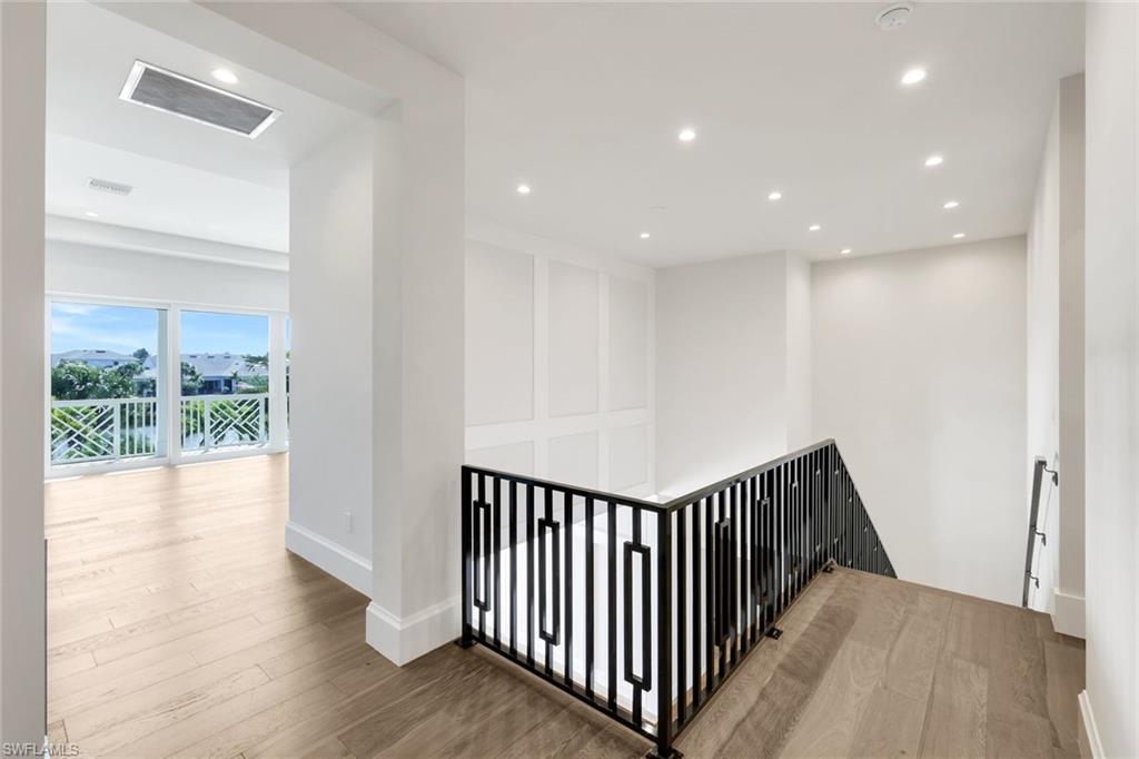 16716 Enclave Circle Naples, FL 34110 - Photo 24 of 50 Corridor with an upstairs landing, wood finished floors, and recessed lighting