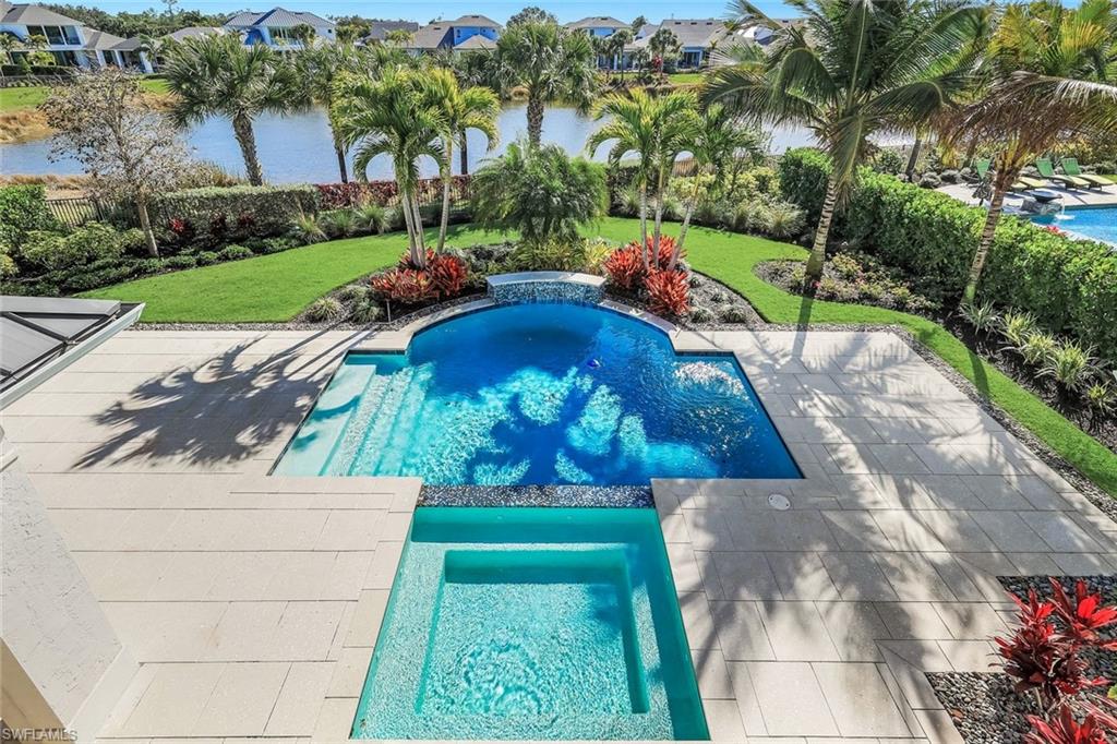 16716 Enclave Circle Naples, FL 34110 - Photo 29 of 50 Integrated pool / spa with a fenced backyard, a residential view, and a patio