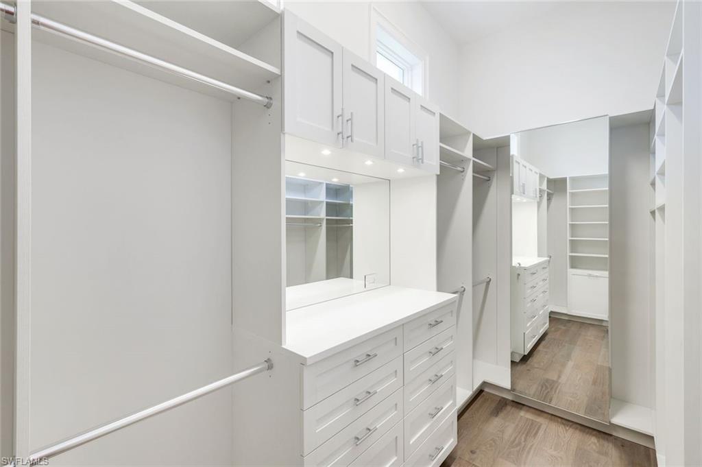 16716 Enclave Circle Naples, FL 34110 - Photo 33 of 50 Walk in closet with light wood-type flooring