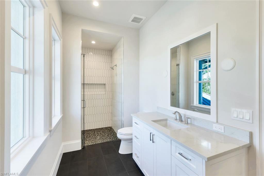 16716 Enclave Circle Naples, FL 34110 - Photo 37 of 50 Bathroom with a shower stall, vanity, dark tile patterned flooring, and recessed lighting