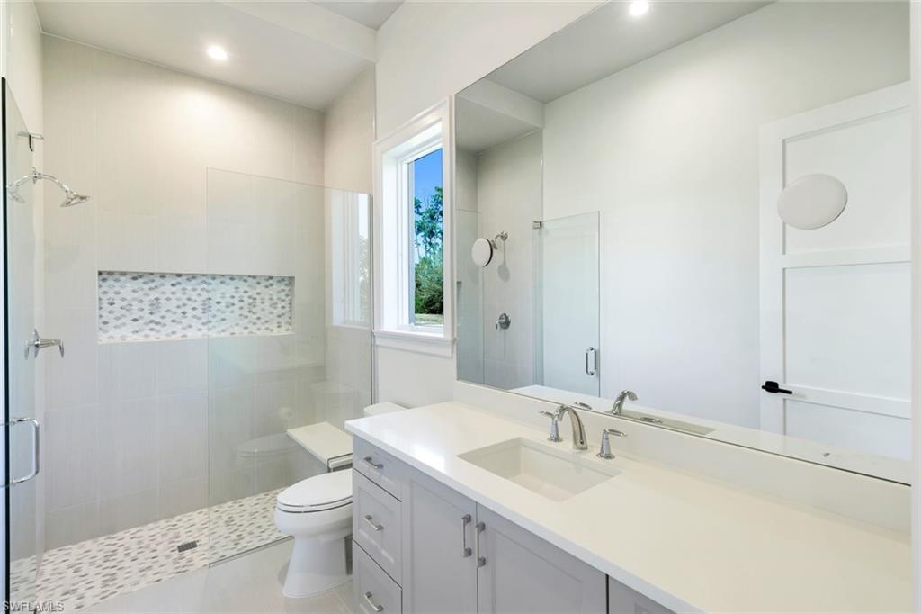 16716 Enclave Circle Naples, FL 34110 - Photo 41 of 50 Full bathroom with a shower stall, vanity, and recessed lighting