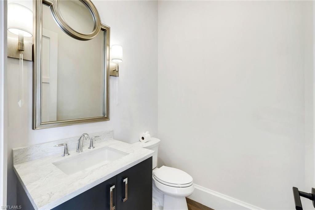 16716 Enclave Circle Naples, FL 34110 - Photo 43 of 50 Half bath featuring vanity and toilet