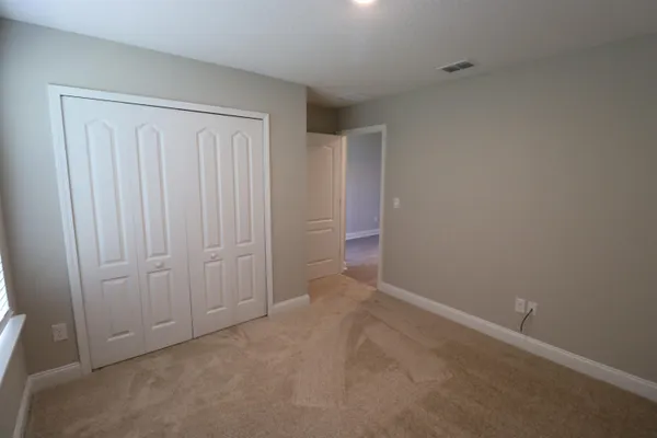 an empty room with closet area