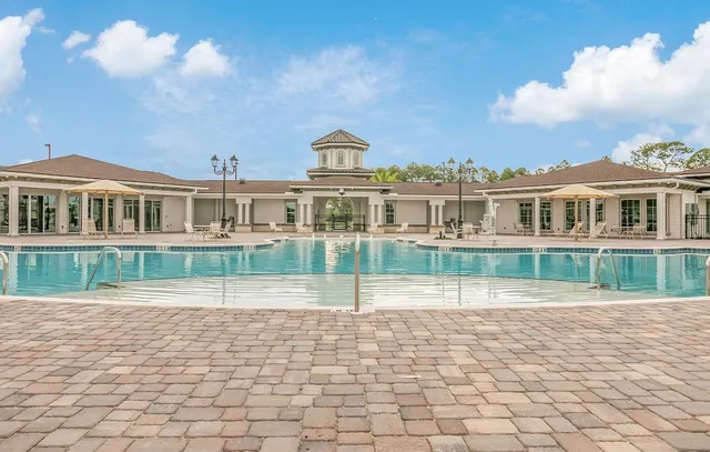 a view of a swimming pool with outdoor seating