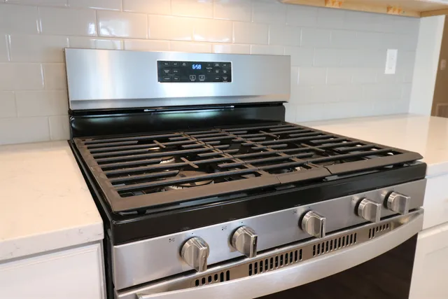 a stove sitting inside of a kitchen