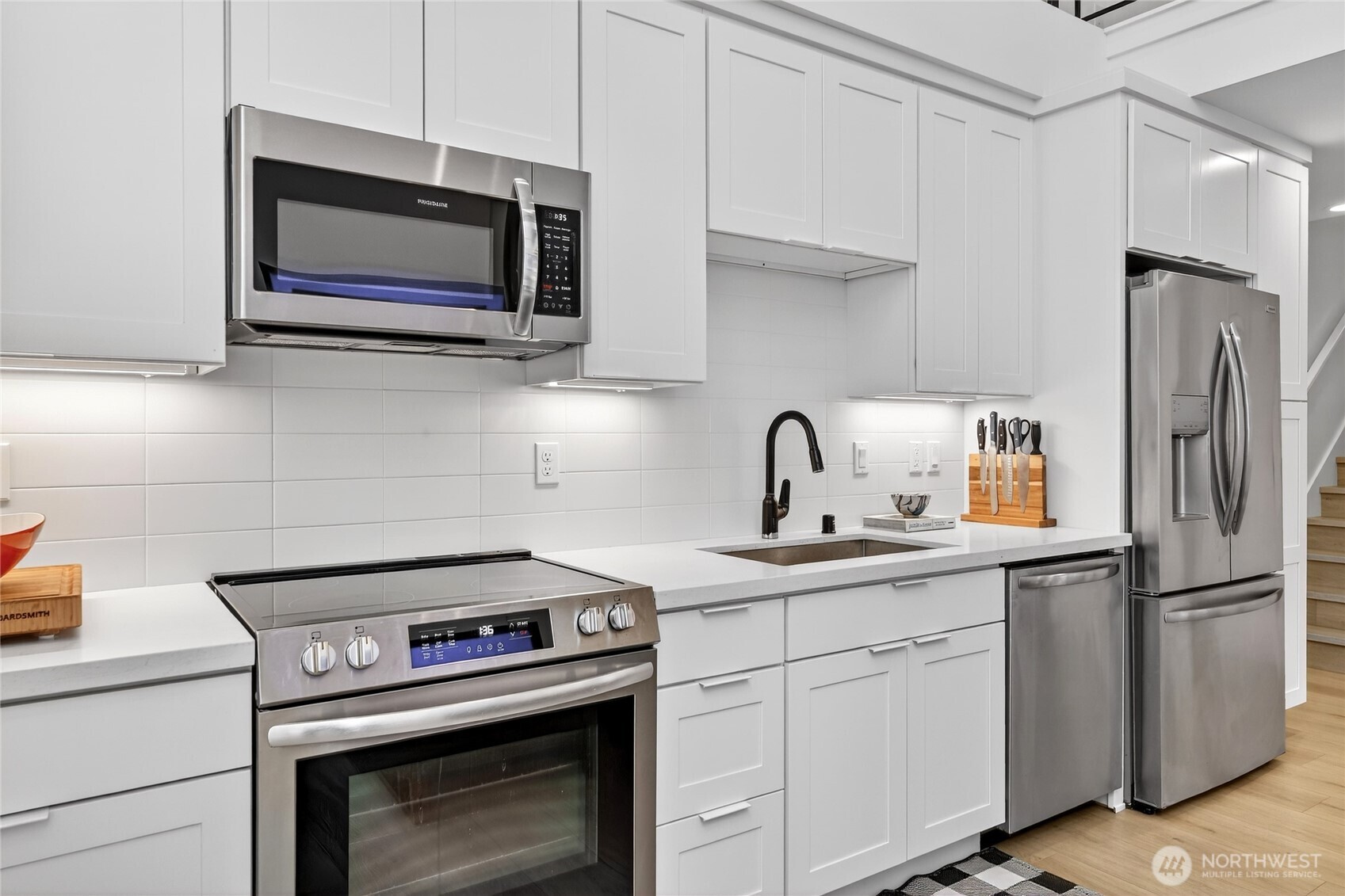 6320 41st Avenue Southwest, Unit B Seattle, WA 98136 - Photo 11 of 31 a kitchen with stainless steel appliances a stove microwave and sink