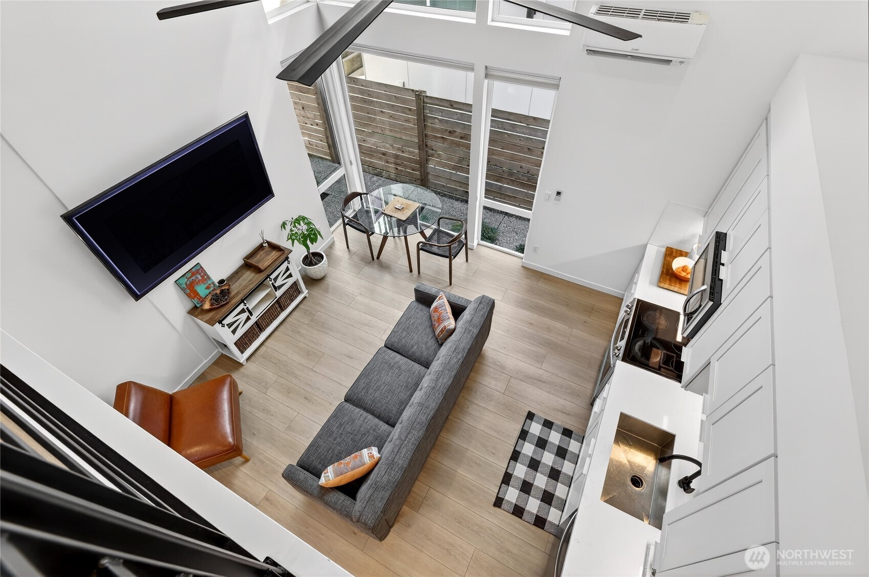 6320 41st Avenue Southwest, Unit B Seattle, WA 98136 - Photo 12 of 31 a living room with furniture and a flat screen tv