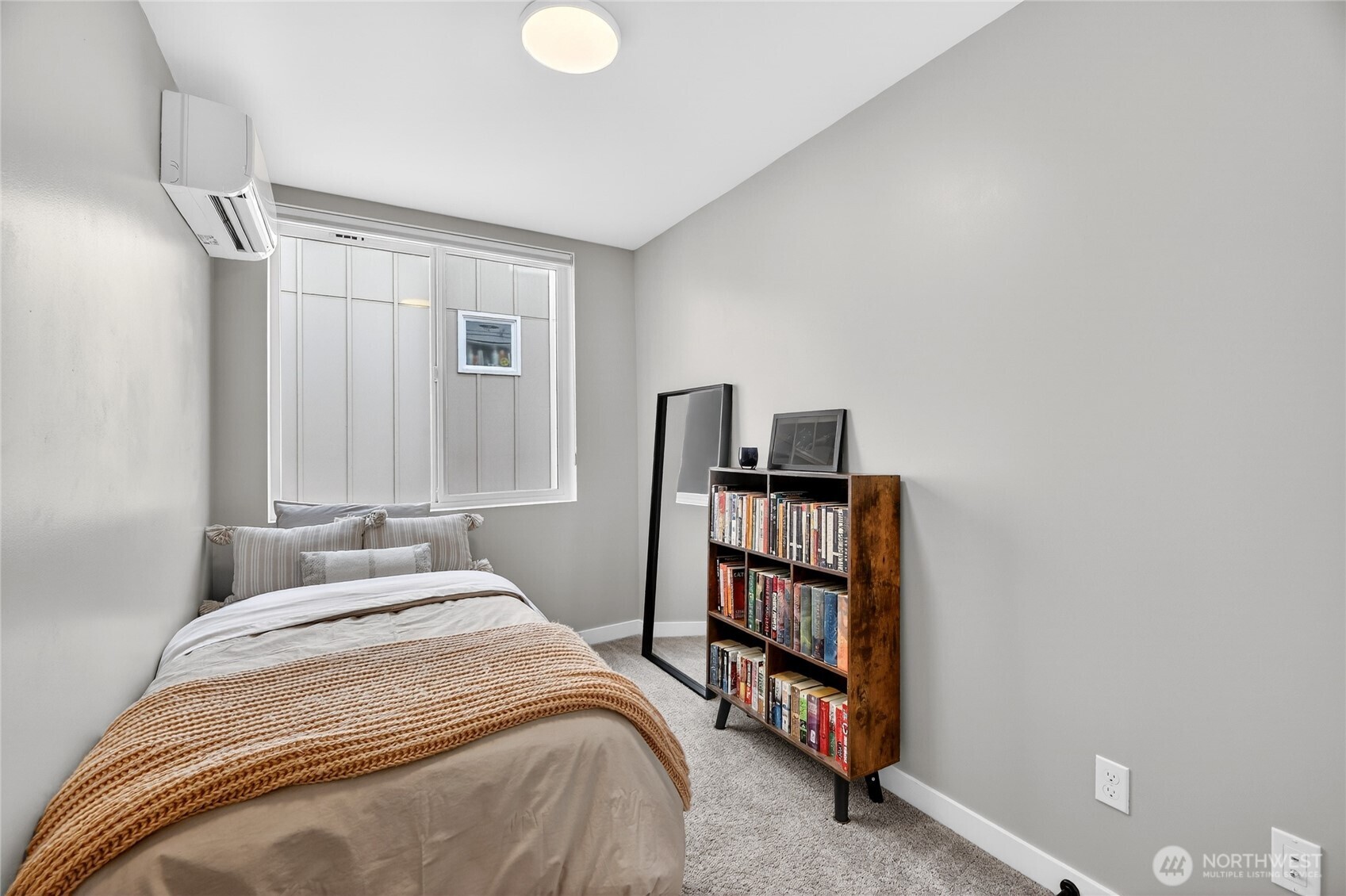 6320 41st Avenue Southwest, Unit B Seattle, WA 98136 - Photo 14 of 31 a bedroom with a bed and a book shelf