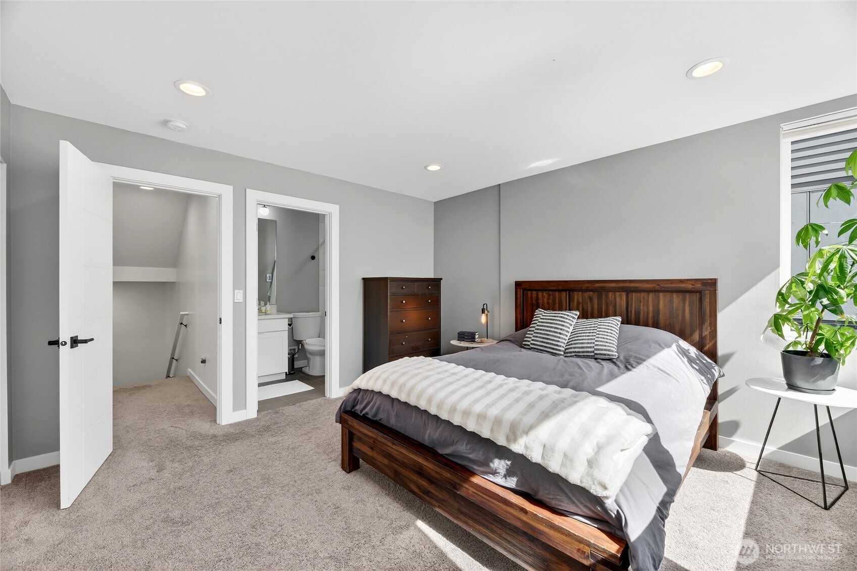 6320 41st Avenue Southwest, Unit B Seattle, WA 98136 - Photo 19 of 31 a bedroom with a bed and a potted plant