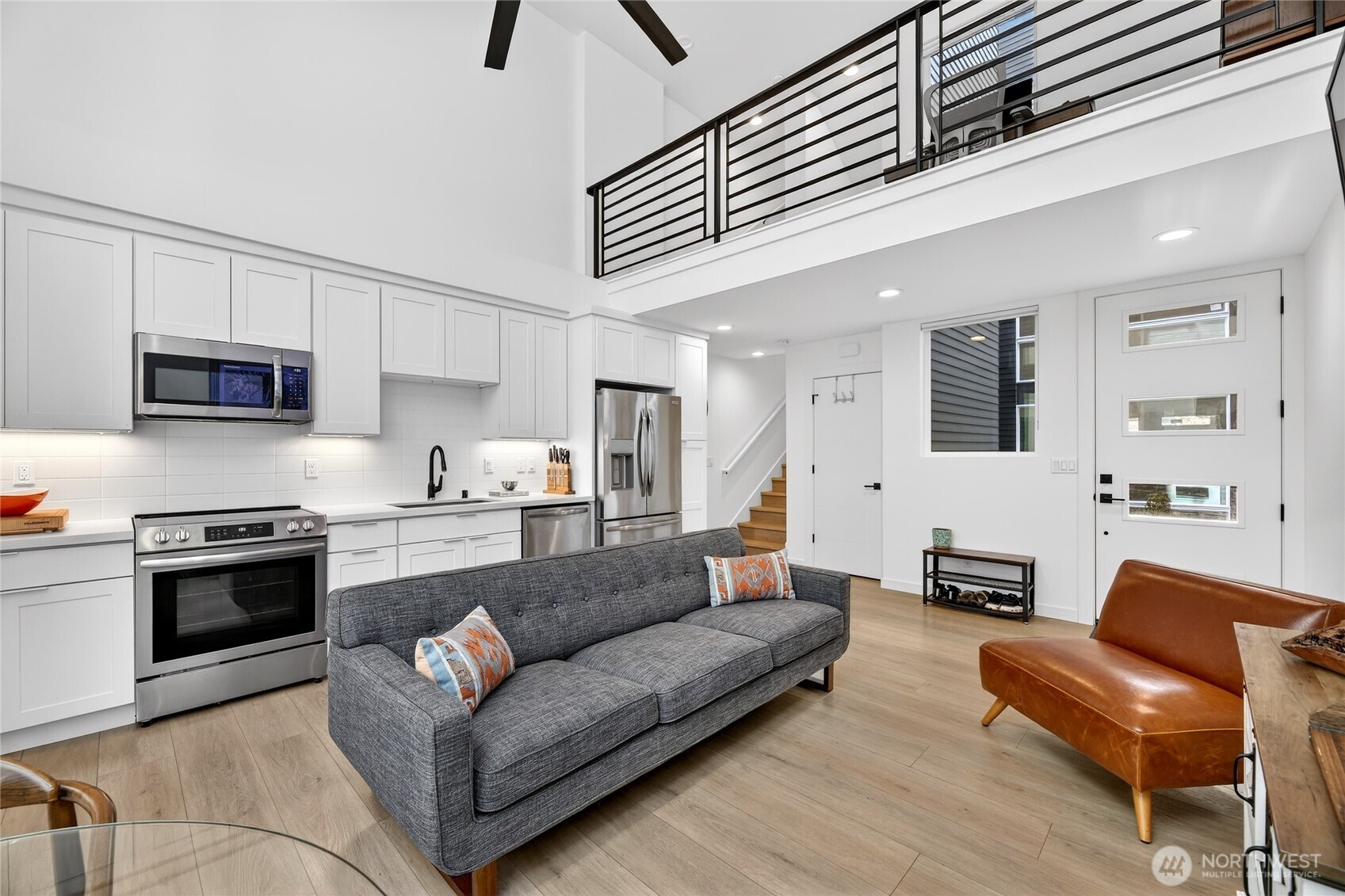 6320 41st Avenue Southwest, Unit B Seattle, WA 98136 - Photo 6 of 31 a living room with furniture kitchen view and a fireplace