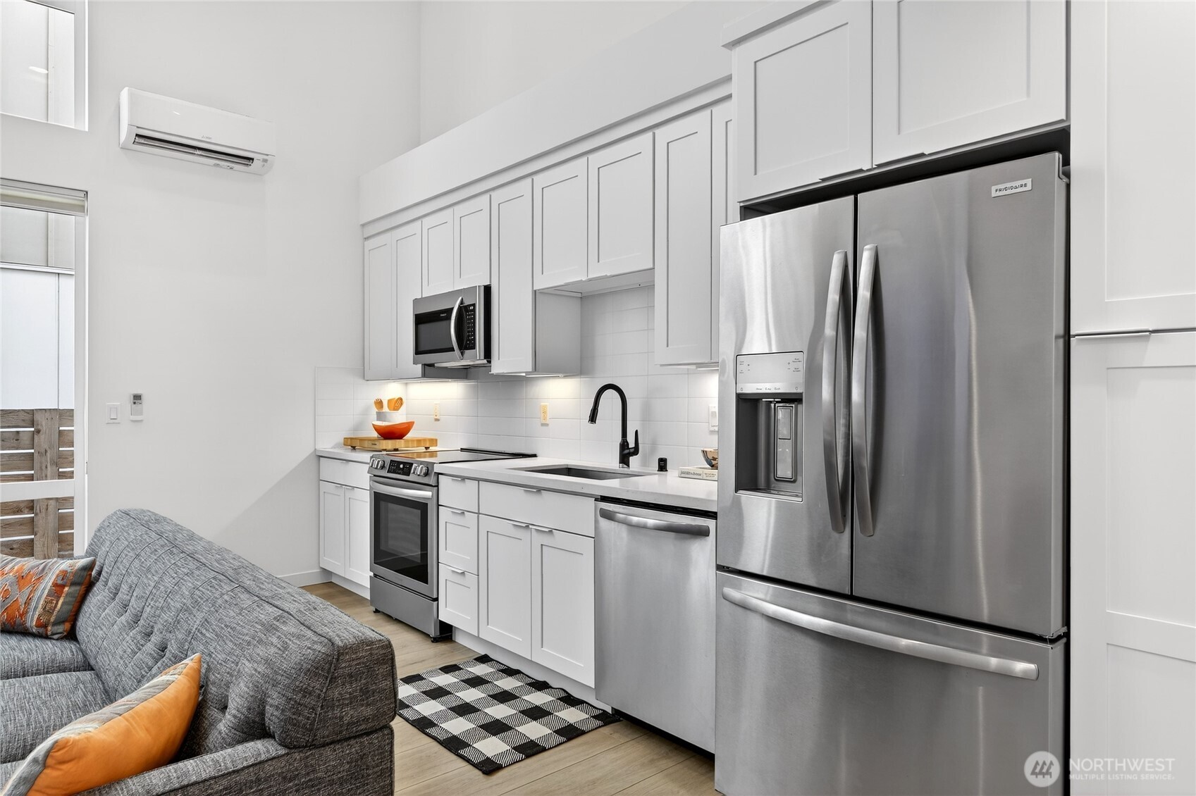 6320 41st Avenue Southwest, Unit B Seattle, WA 98136 - Photo 9 of 31 a kitchen with stainless steel appliances a refrigerator stove and sink