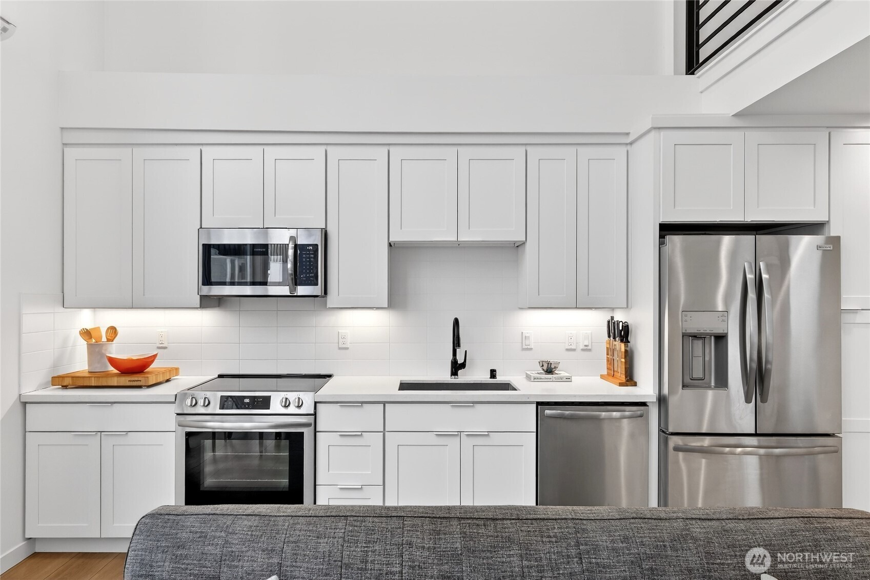 6320 41st Avenue Southwest, Unit B Seattle, WA 98136 - Photo 10 of 31 a kitchen with white cabinets and stainless steel appliances
