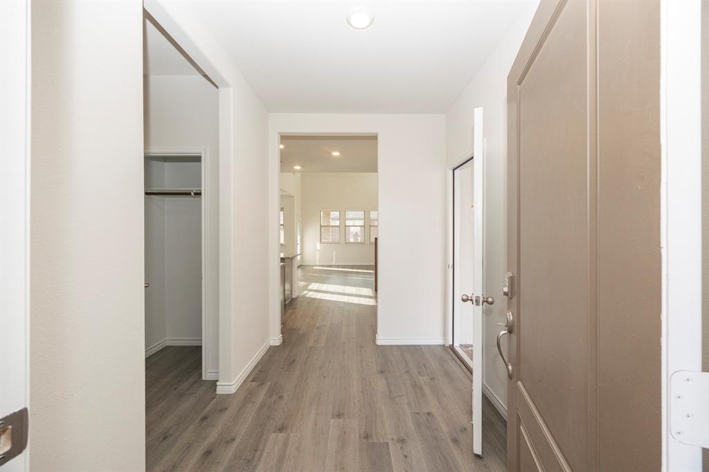 1001 Marigold Street Princeton, TX 75407 - Photo 11 of 37 a view of a hallway with wooden floor and a bathroom