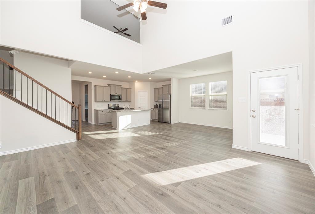 1001 Marigold Street Princeton, TX 75407 - Photo 16 of 37 a view of a kitchen with wooden floor and a kitchen space