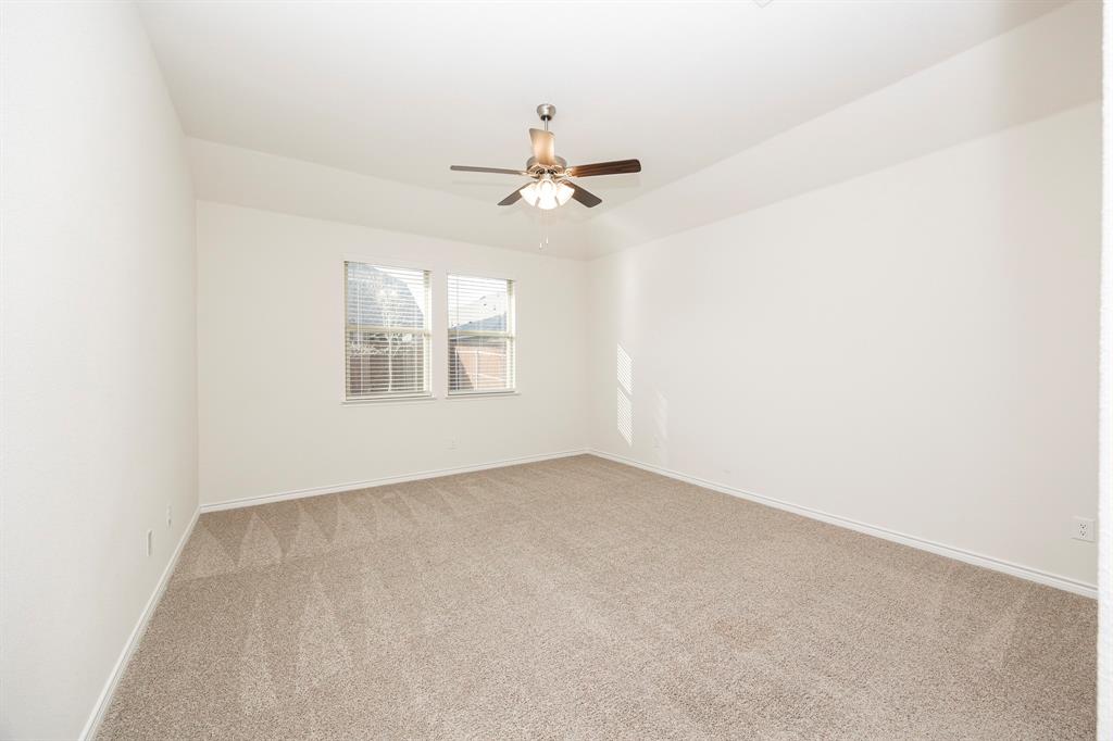 1001 Marigold Street Princeton, TX 75407 - Photo 17 of 37 an empty room with windows and ceiling fan